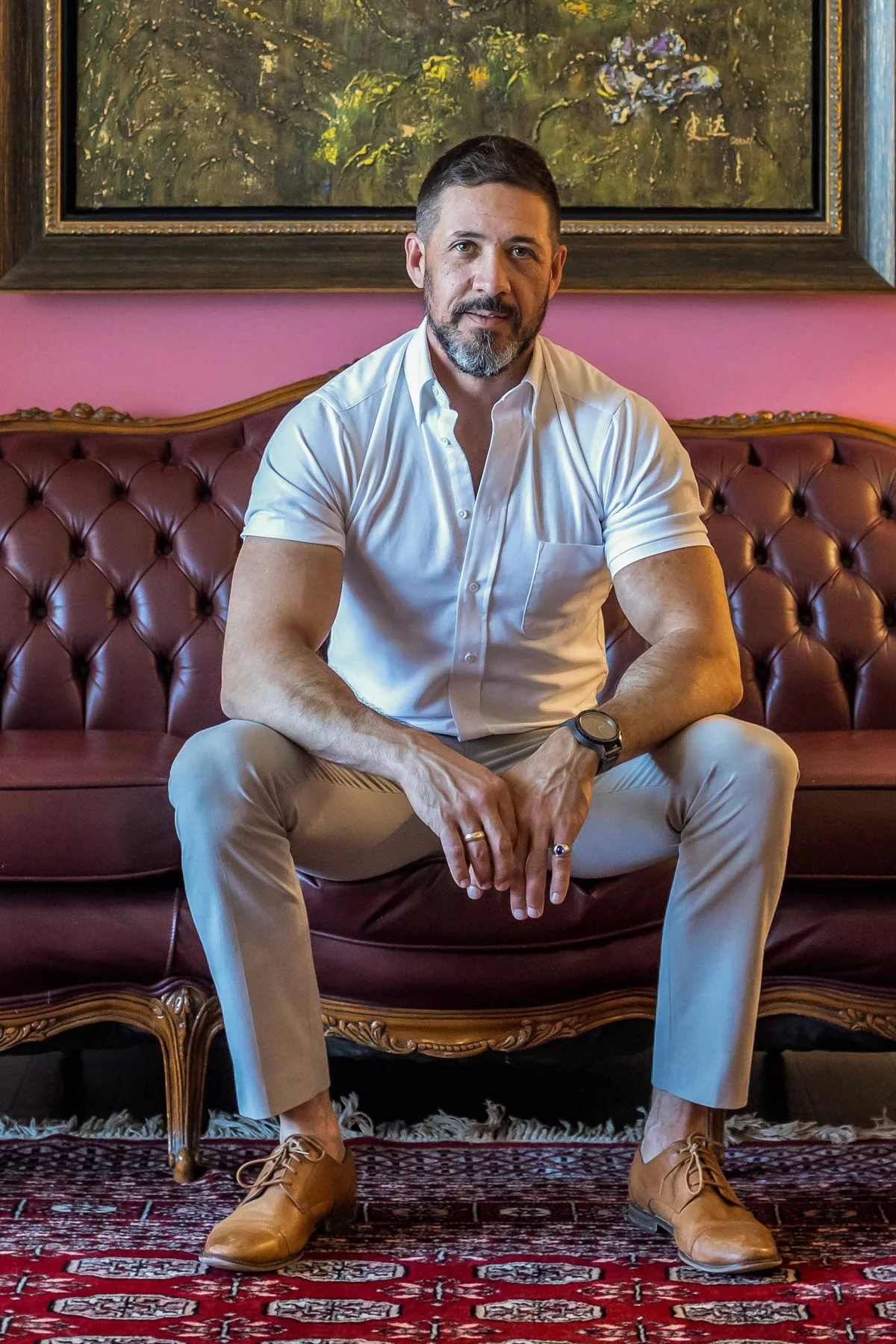 Jon Alonzo, Burford REALTOR®, seated on a leather sofa